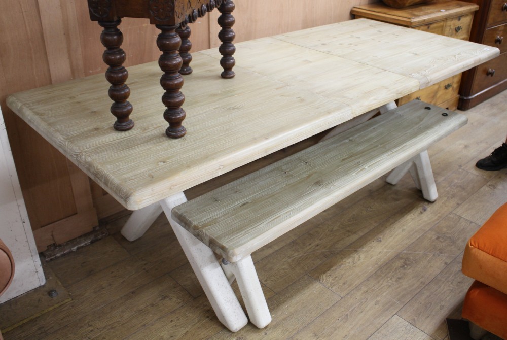A Loaf pine extending refectory table, extended L.215.5cm W.89.5cm H.77cm, with painted X frame, together with a matching bench, L.160c